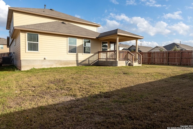 back of property with a yard and cooling unit