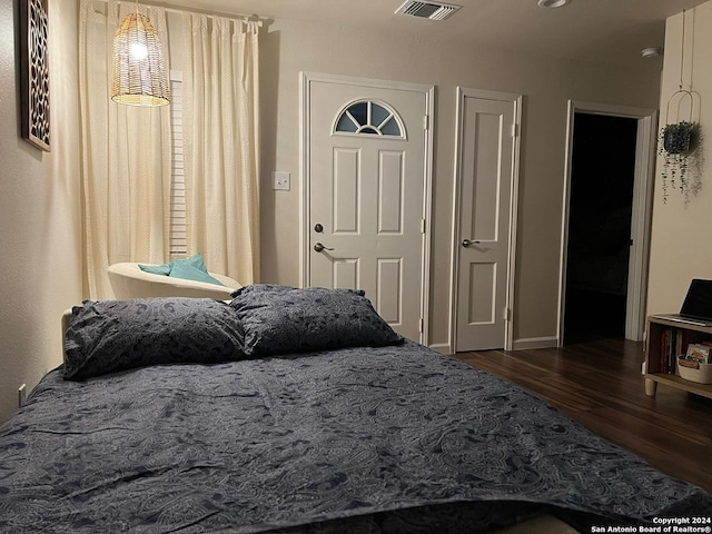 bedroom with dark wood-type flooring