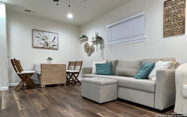 living room featuring dark hardwood / wood-style flooring and ceiling fan