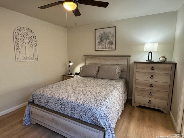 bedroom with ceiling fan and hardwood / wood-style flooring