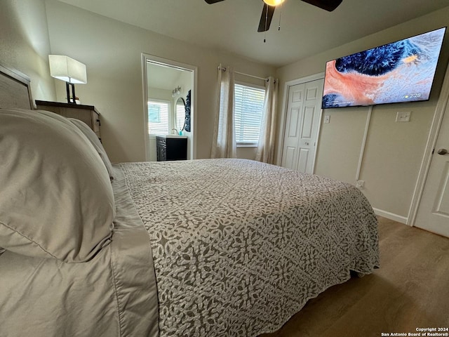 bedroom featuring ceiling fan, a closet, and hardwood / wood-style floors