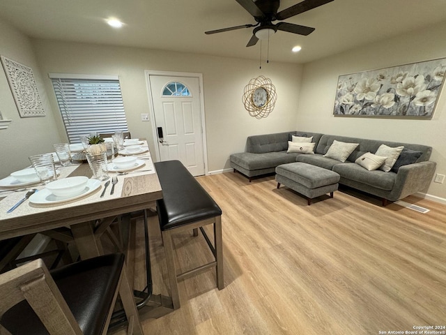 dining space with light hardwood / wood-style flooring and ceiling fan