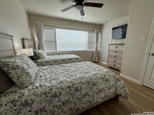 bedroom featuring ceiling fan and wood-type flooring