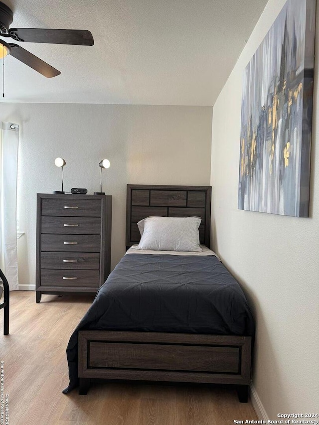 bedroom featuring ceiling fan and light hardwood / wood-style flooring