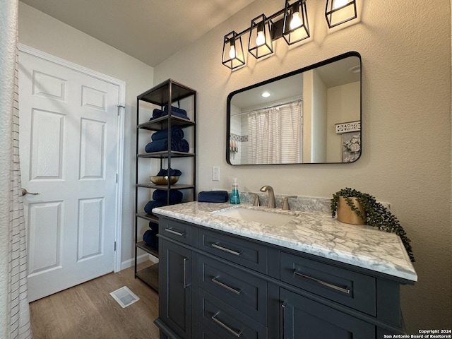 bathroom with vanity and wood-type flooring