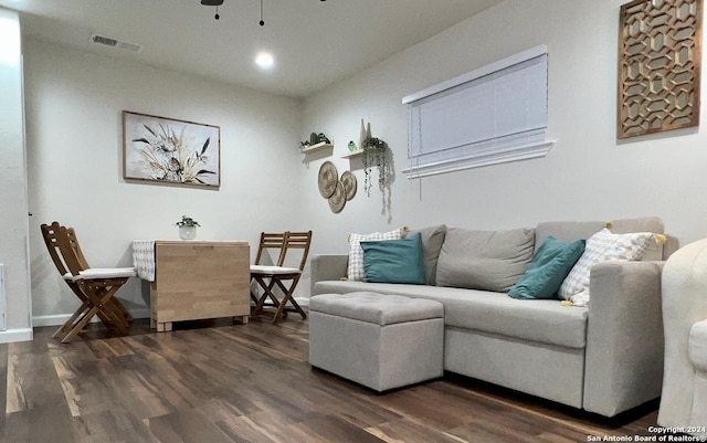 living room featuring dark hardwood / wood-style floors and ceiling fan