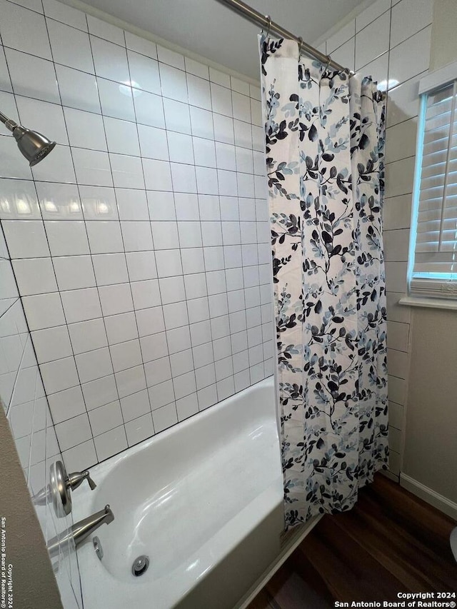 bathroom featuring hardwood / wood-style floors and shower / tub combo