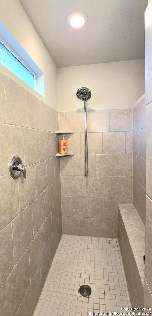 bathroom with a tile shower