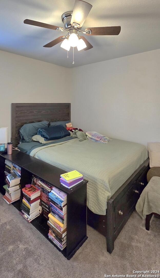 carpeted bedroom featuring ceiling fan