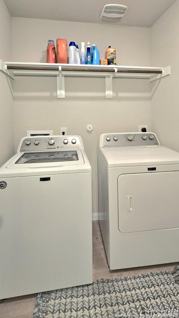 clothes washing area with independent washer and dryer