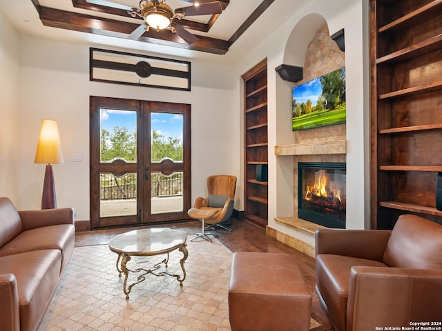 living room featuring french doors, light wood-type flooring, built in features, and ceiling fan