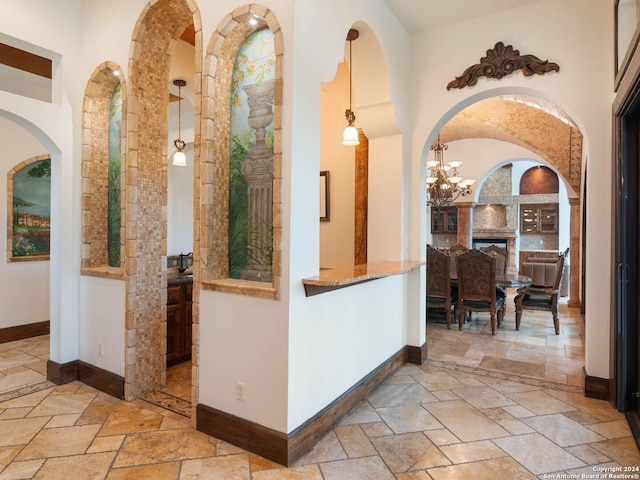 corridor with a high ceiling and an inviting chandelier