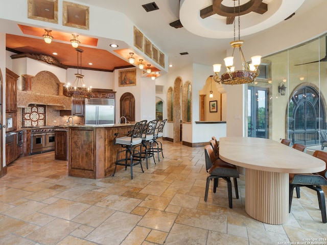 kitchen featuring pendant lighting, premium appliances, and an inviting chandelier