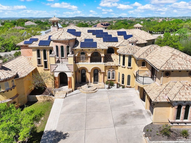 mediterranean / spanish home featuring solar panels