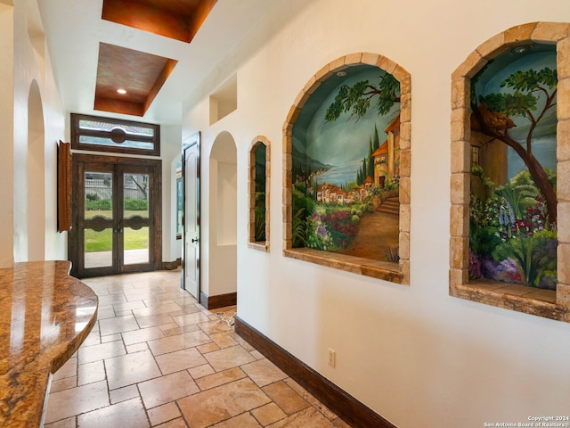 interior space featuring coffered ceiling and french doors