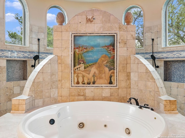 bathroom featuring tile walls and tiled tub