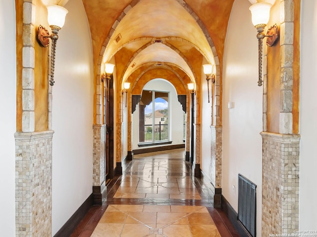 hall featuring vaulted ceiling