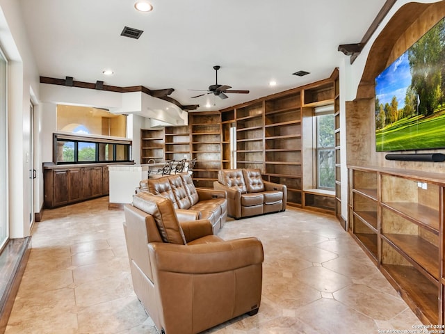 living room featuring built in features and ceiling fan