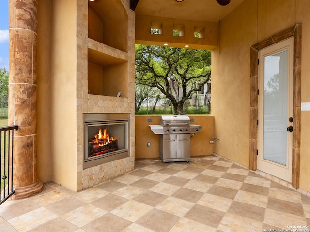 view of patio with area for grilling and a fireplace