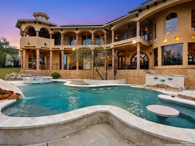 view of pool at dusk