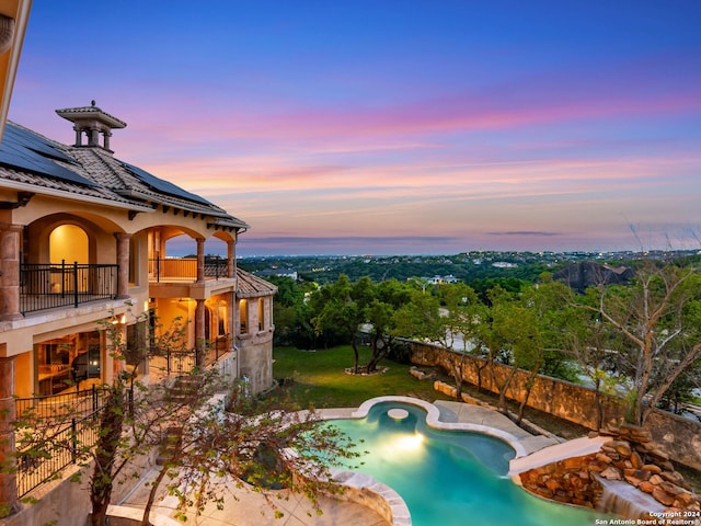 view of pool at dusk