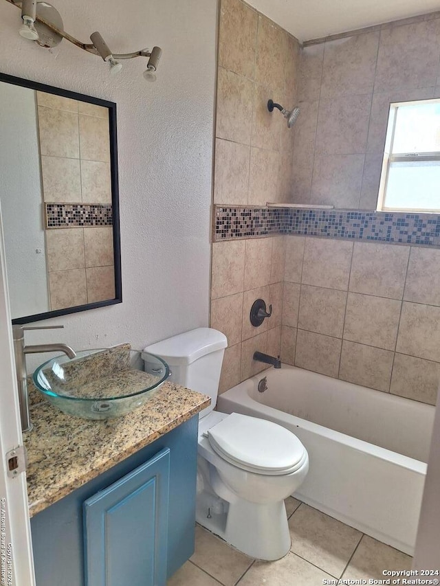 full bathroom with tile patterned floors, vanity, toilet, and tiled shower / bath