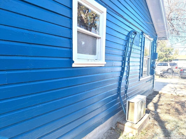 view of side of home featuring ac unit