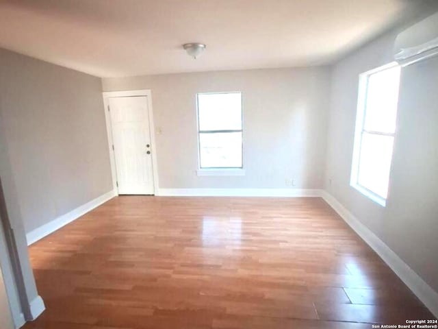 unfurnished room with wood-type flooring