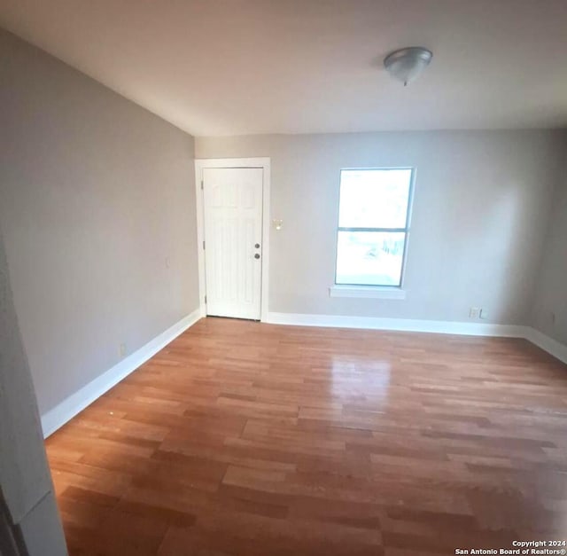 empty room with hardwood / wood-style floors