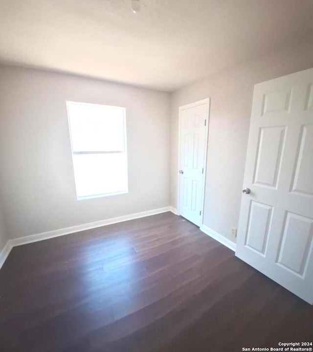 empty room with dark hardwood / wood-style floors