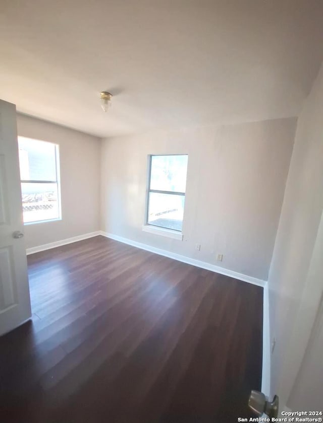 unfurnished room featuring dark hardwood / wood-style floors