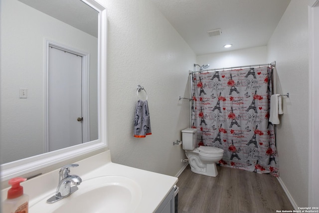 full bathroom featuring wood-type flooring, vanity, toilet, and shower / tub combo with curtain