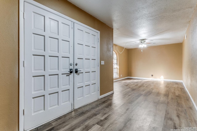 entrance foyer featuring ceiling fan, hardwood / wood-style floors, and a textured ceiling