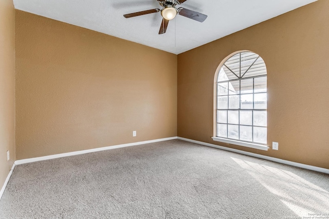 empty room featuring carpet floors and ceiling fan