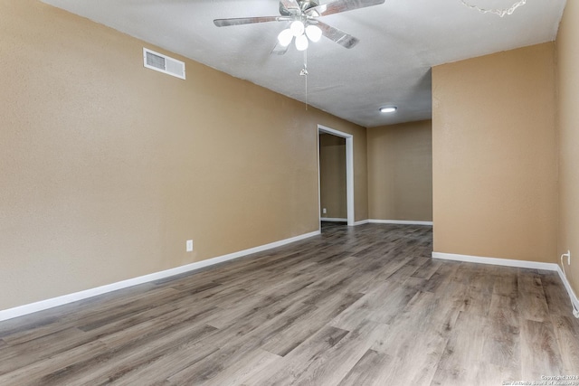 unfurnished room with hardwood / wood-style floors and ceiling fan