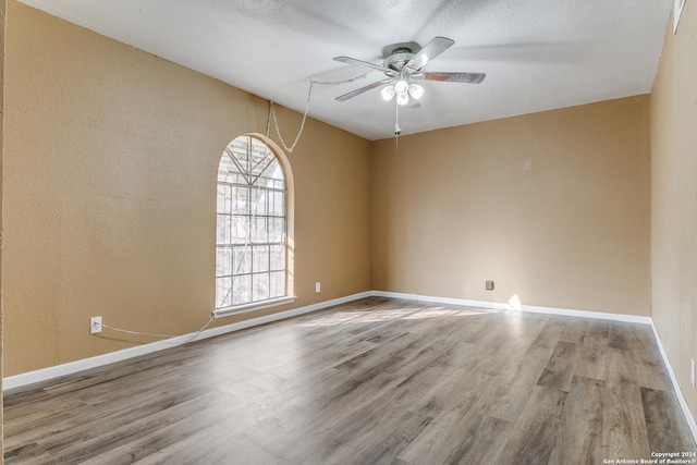 unfurnished room with ceiling fan and light hardwood / wood-style floors