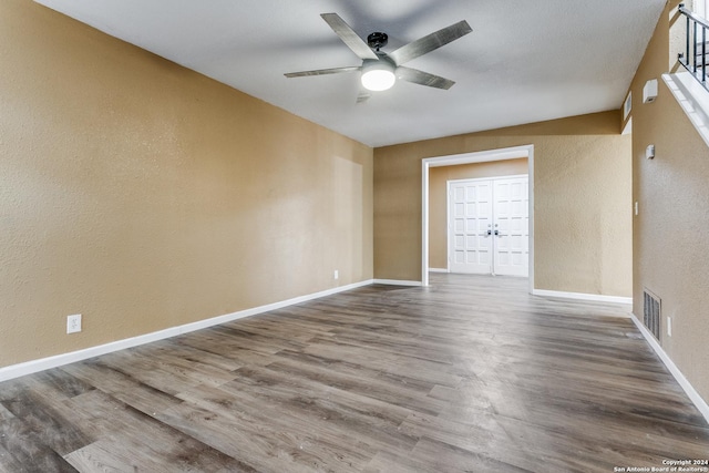 empty room featuring wood-type flooring and ceiling fan