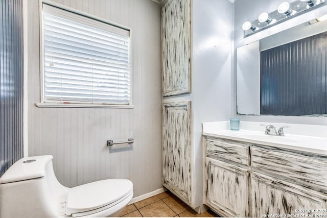 bathroom with tile patterned flooring, vanity, and toilet