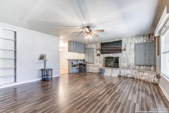 unfurnished living room featuring a fireplace, built in features, and wood-type flooring