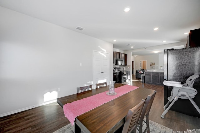 dining space with dark hardwood / wood-style flooring