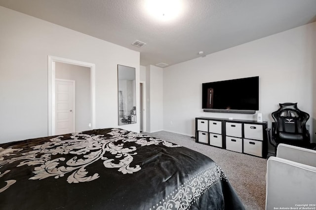 carpeted bedroom featuring a textured ceiling