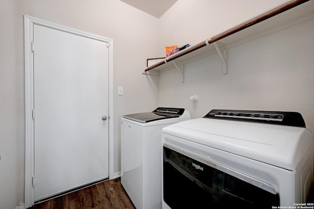 laundry area featuring dark hardwood / wood-style flooring and washer and clothes dryer