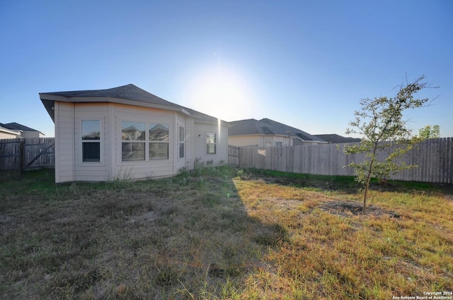 back of house with a lawn