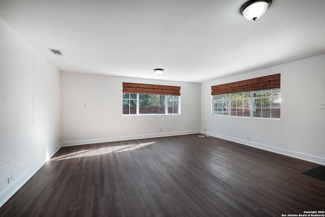 spare room with dark hardwood / wood-style floors