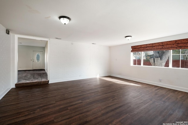 unfurnished room with dark hardwood / wood-style floors