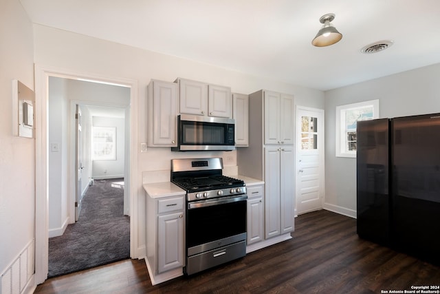 kitchen with dark wood-type flooring and appliances with stainless steel finishes