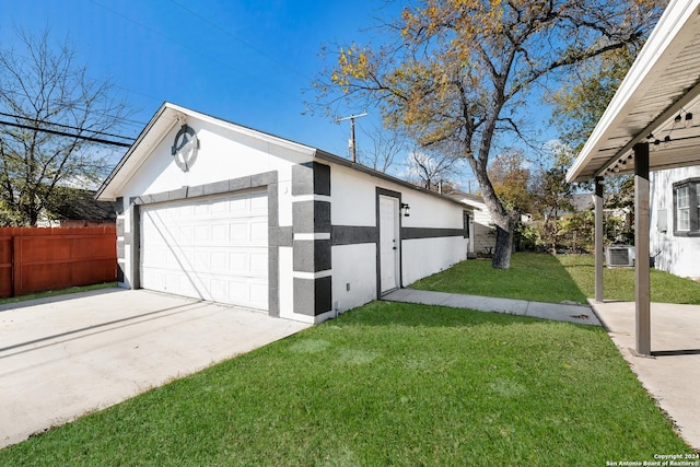 garage with central AC and a yard