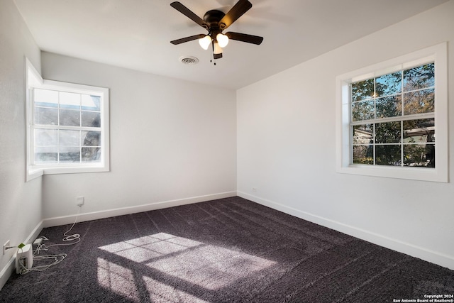 carpeted spare room with ceiling fan