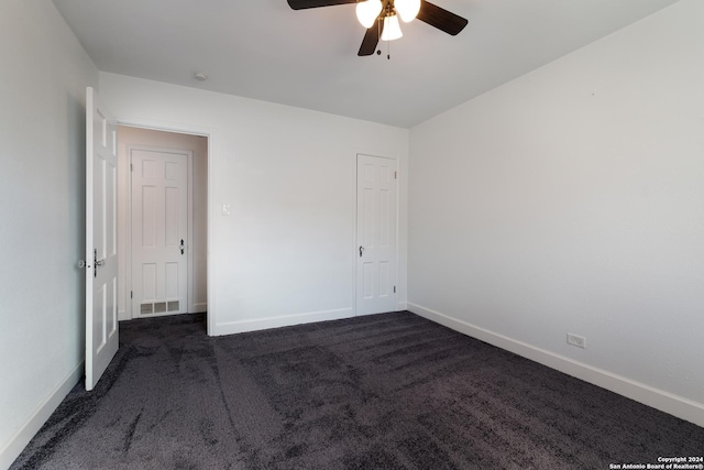 carpeted empty room featuring ceiling fan