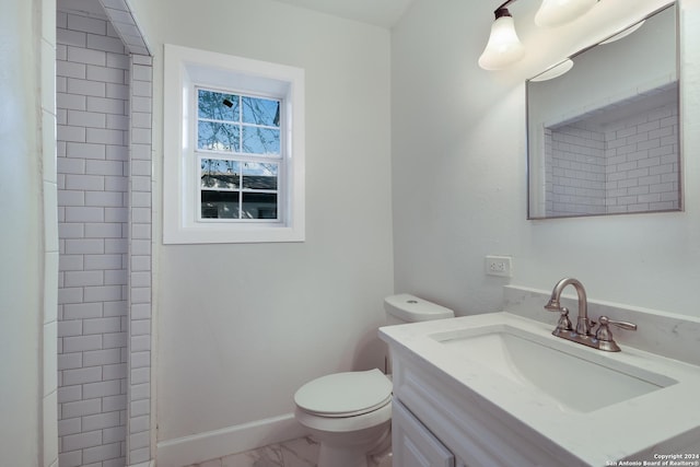 bathroom featuring vanity, toilet, and walk in shower